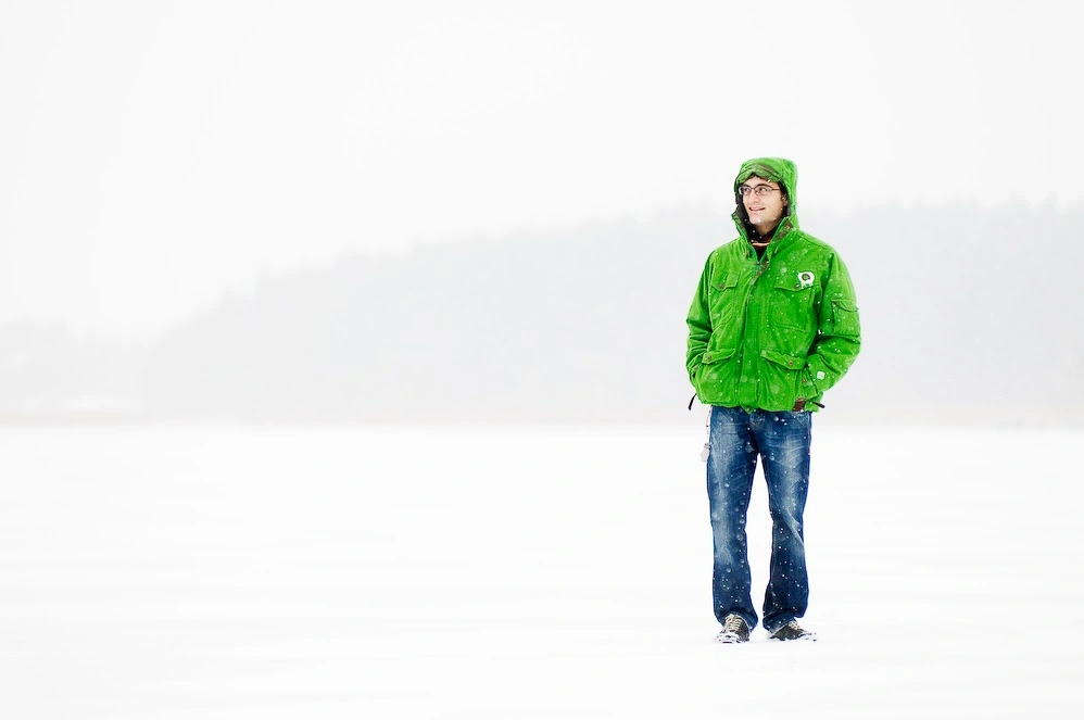 Myself standing and smiling on a frozen lake in the snow